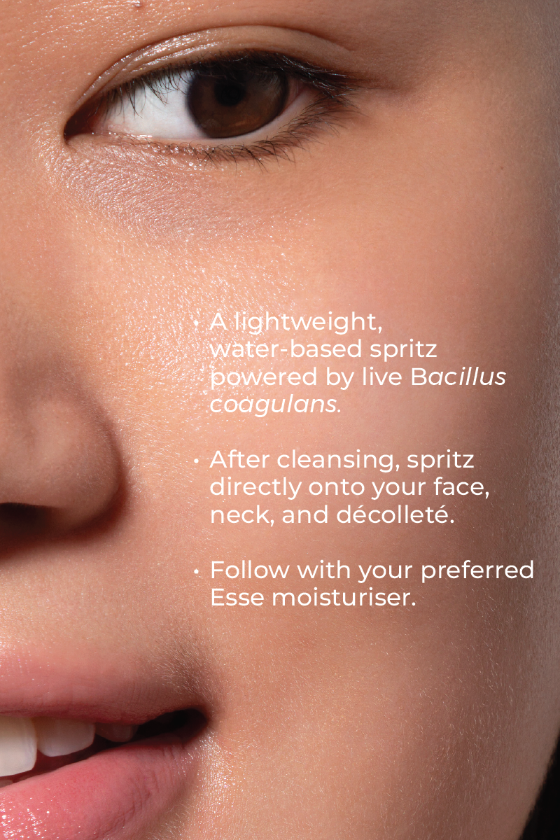 Close-up of a woman's smooth skin. Text highlights Live Probiotic Mist, a water-based spritz with Bacillus coagulans. Instructions: spritz after cleansing and follow with Esse moisturizer.