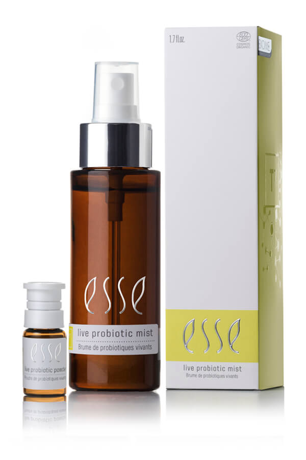 A 1.7 fl oz brown spray bottle and a small vial of Esse Live Probiotic Mist are shown beside a white and yellow branded box.